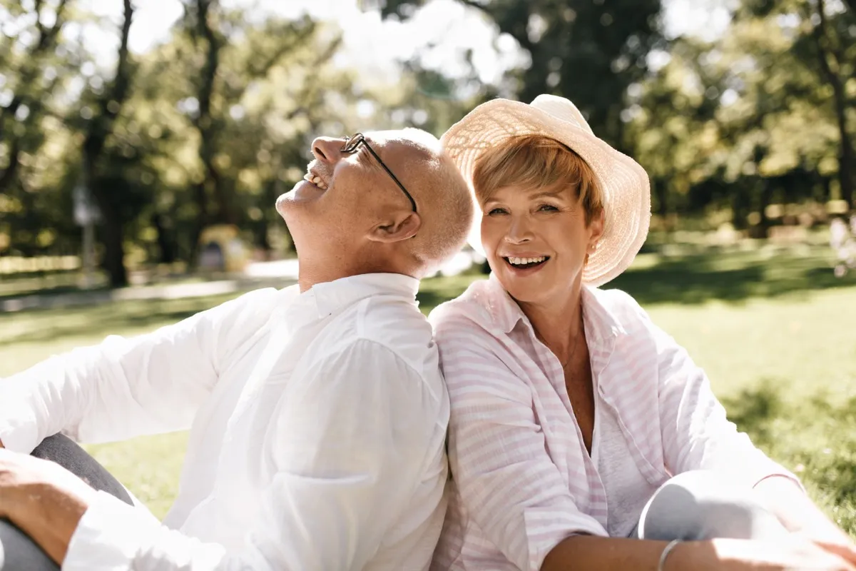 A woman and an older man enjoying time outdoors, representing family financial protection